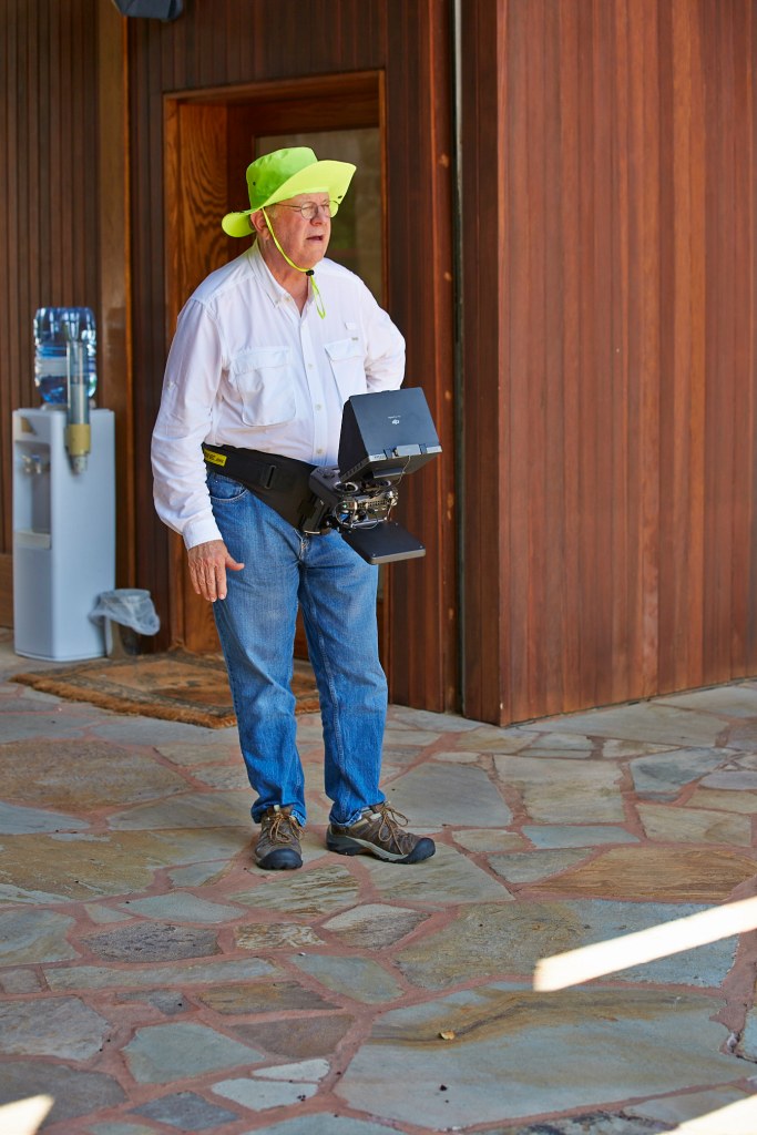 Drone pilot with waist-belt flight controls and view monitor.